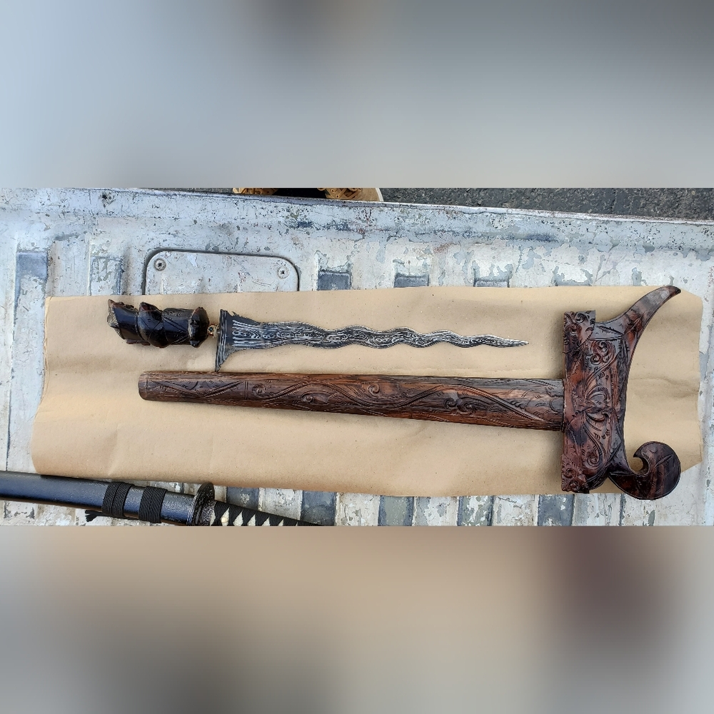 Intricately Carved Wooden Sheath with Silver Blade